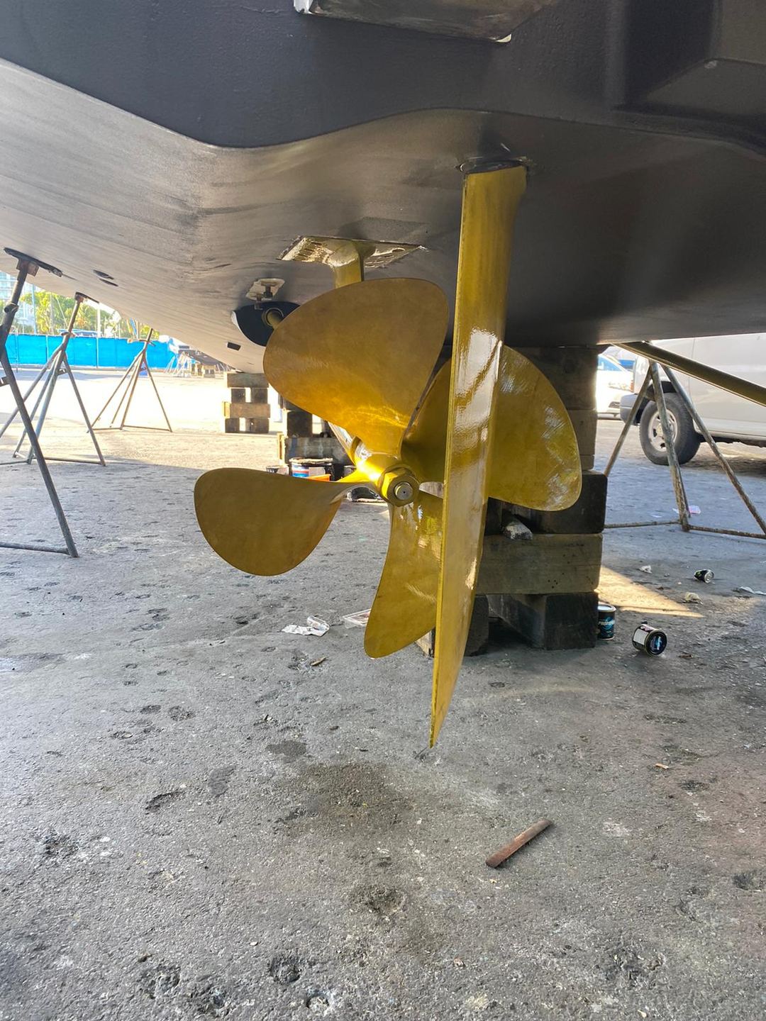 Freshly coated propeller and rudder under a boat hull in the yard