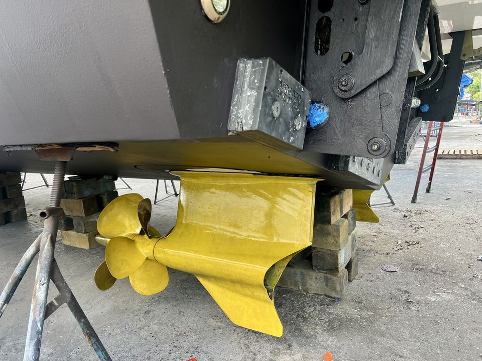 Freshly painted hull bottom and coated propellers on a boat in the yard